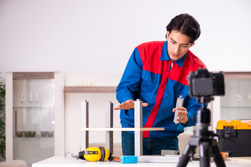 Young contractor recording video for his blog 