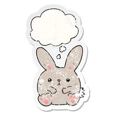cartoon rabbit and thought bubble as a distressed worn sticker