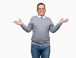 Middle age bussines arab man wearing glasses over isolated background Smiling showing both hands open palms, presenting and advertising comparison and balance