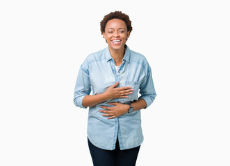 Young beautiful african american woman over isolated background Smiling and laughing hard out loud because funny crazy joke. Happy expression.
