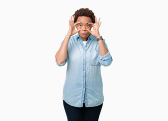 Young beautiful african american woman over isolated background Trying to open eyes with fingers, sleepy and tired for morning fatigue