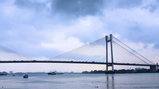 4K Timelapse beautiful clouds over Kolkata city with a view of Vidyasagar Bridge or Seconf Hooghly Bridge on the Ganges river, West Bengal, India.