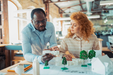 Man and woman working on green city project discussing details