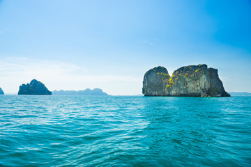 Landscape with rocky islands in tropical sea and blue sky