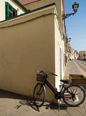 Fototapeta na wymiar Alghero, Sardinia, Italy - A lonely bicycle on the seafront
