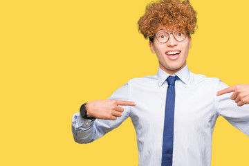 Young handsome business man with afro wearing glasses looking confident with smile on face,...