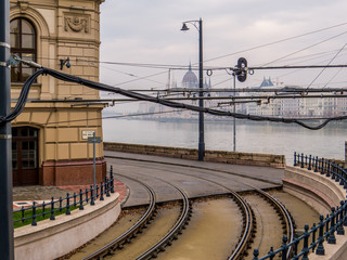 Budapest, Hungary - View of tram tracks with the Danube river and the landmark Hungarian Parliament building in the background