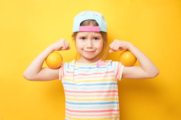 Attractive little girl shows the biceps on yellow background. Feel so powerful. Girls rules concept. Upbringing advices for girls. Strong and powerful
