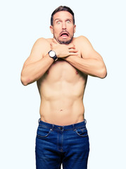 Fototapeta premium Handsome shirtless man showing nude chest shouting and suffocate because painful strangle. Health problem. Asphyxiate and suicide concept.