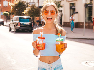 Young beautiful smiling hipster woman in sunglasses.Girl in summer trendy clothes posing in the...