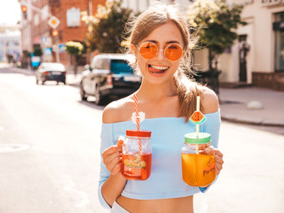 Young beautiful smiling hipster woman in sunglasses.Girl in summer trendy clothes posing in the...
