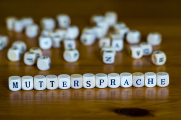 Mother tongue written with wooden cube