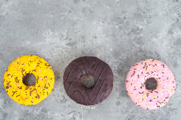Obraz na płótnie Canvas Sweet tasty donuts with colorful icing.