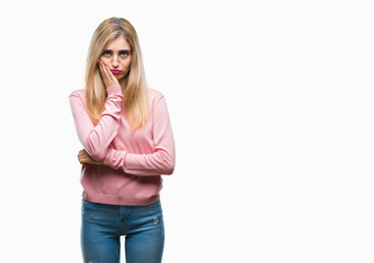Young beautiful blonde woman wearing pink winter sweater over isolated background thinking looking tired and bored with depression problems with crossed arms.
