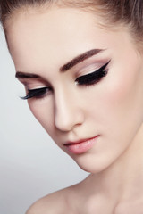 Fototapeta premium Close-up portrait of young beautiful girl with winged eye makeup