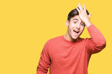 Young handsome man over isolated background surprised with hand on head for mistake, remember...