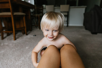 Adorable Cute Little Long Blonde Haired Blue Eyed Toddler Kid Boy Face Expressions Head Shots at Home Playing with Mom