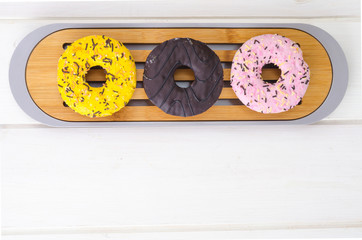 Sweet tasty donuts with colorful icing.