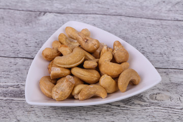 Fototapeta premium Cashew nuts heap in the bowl