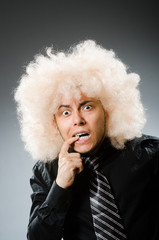 Young man wearing afro wig