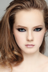 Portrait of young beautiful girl with smoky eye makeup