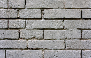 Obraz premium An old, damaged wall of gray bricks - a wabi-sabi style background