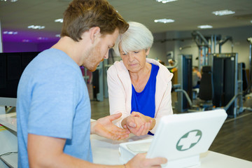 woman at fitness-center reception with injured wrist