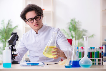 Young male biochemist working in the lab 