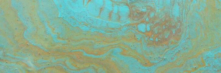 photography of abstract marbleized effect background. Blue, mint and gold creative colors. Beautiful paint