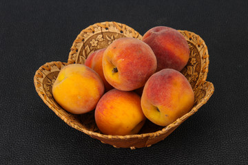 Peach heap in the wooden basket