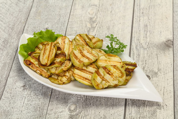 Grilled eggplant slices served basil
