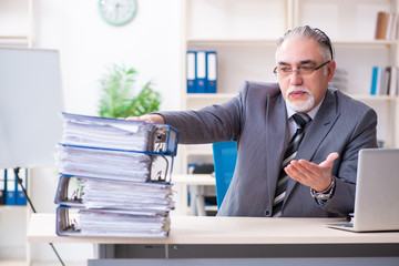 Aged male employee unhappy with excessive work 