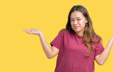 Young beautiful brunette woman over isolated background clueless and confused expression with arms...