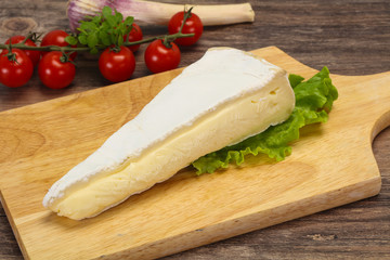 Fototapeta na wymiar Brie cheese triangle served salad