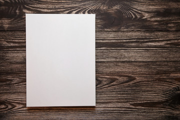 White blank cotton canvas on brown wooden background. Mockup