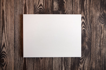 White blank cotton canvas on brown wooden background. Mockup