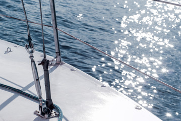 background - yachting. fragment of the hull of a sailing vessel with rigging against the backdrop...
