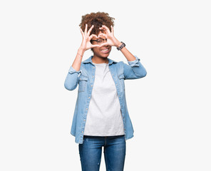 Beautiful young african american woman wearing glasses over isolated background Doing heart shape with hand and fingers smiling looking through sign