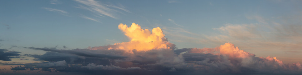 Dramatic Panoramic View of a cloudscape during a dark, rainy and colorful morning sunrise. Taken...