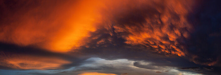 Dramatic Panoramic View of a cloudscape during a dark and colorful sunset. Taken over Beach Ancon...