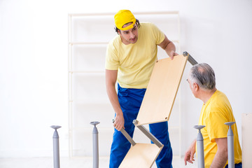 Two contractors carpenters working indoors 