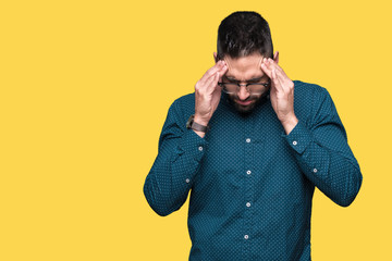 Young handsome business man wearing glasses over isolated background with hand on head for pain in head because stress. Suffering migraine.