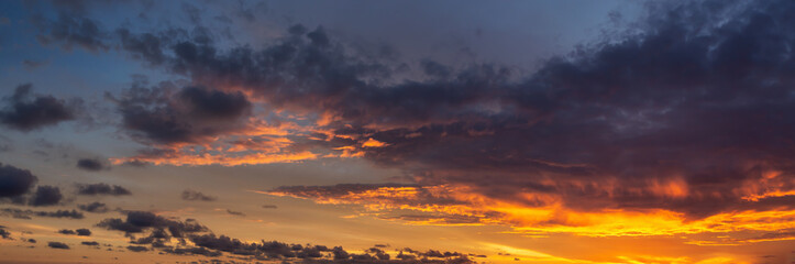 Dramatic Panoramic View of a cloudscape during a dark and colorful sunset. Taken over Beach Ancon in Trinidad, Cuba.