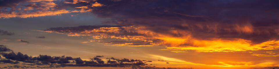 Dramatic Panoramic View of a cloudscape during a dark and colorful sunset. Taken over Beach Ancon in Trinidad, Cuba.