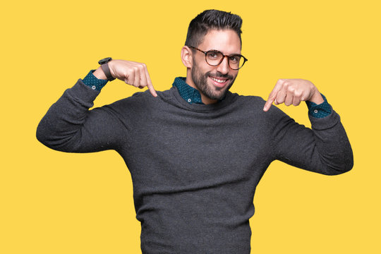 Young handsome man wearing glasses over isolated background looking confident with smile on face, pointing oneself with fingers proud and happy.