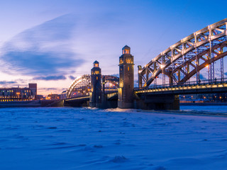 Obraz premium Bolsheokhtinsky Bridge with the frozen Neva River. In St. Petersburg, Russia