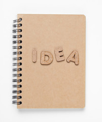 I have an idea! Notebook with craft paper with word idea on white background.