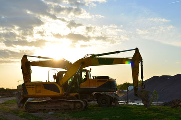 Wheel and tracked heavy excavators working at construction site. hydraulic excavator crane at building site on sunny day - Image