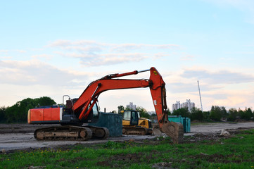 Crawler excavator in construction site on blue sky background. Special heavy construction equipment - Image
