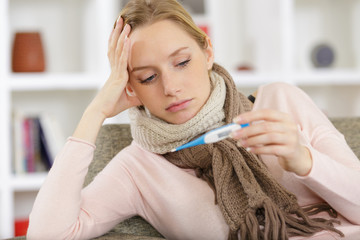 ill woman has fever checking body temperature